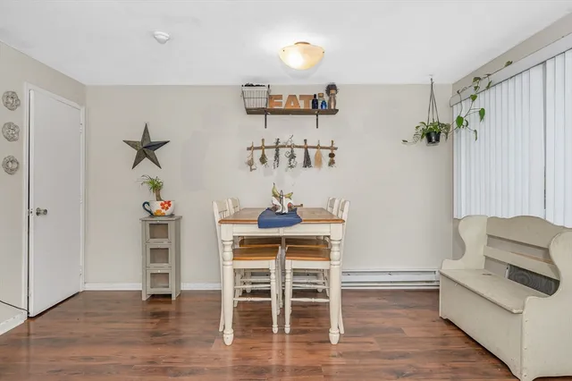 a dining room with furniture and wooden floor