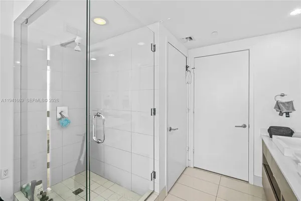 a bathroom with a shower and a glass door