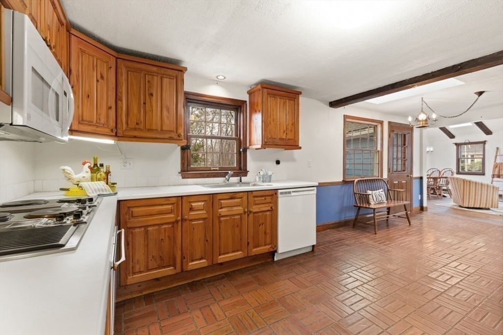17 Sturges Road Reading, MA 01867 - Photo 11 of 29 a kitchen with stainless steel appliances granite countertop a stove a sink and a refrigerator