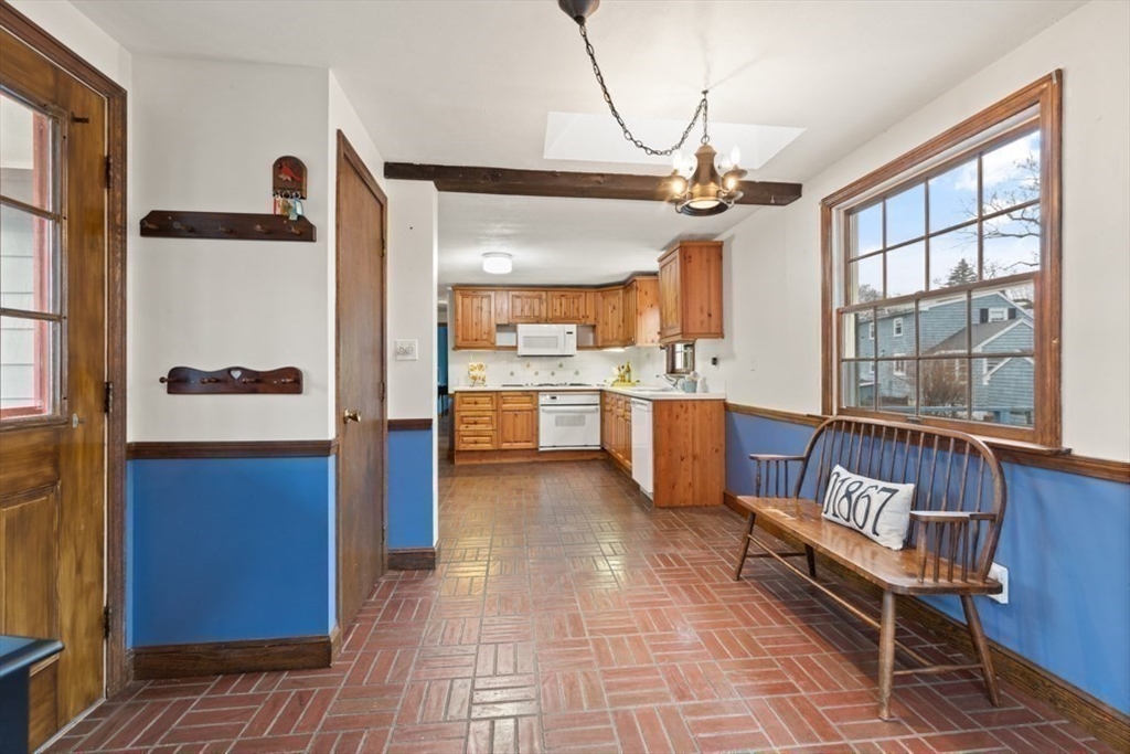 17 Sturges Road Reading, MA 01867 - Photo 12 of 29 a open kitchen with stainless steel appliances granite countertop a refrigerator a sink dishwasher a dining table and chairs with wooden floor