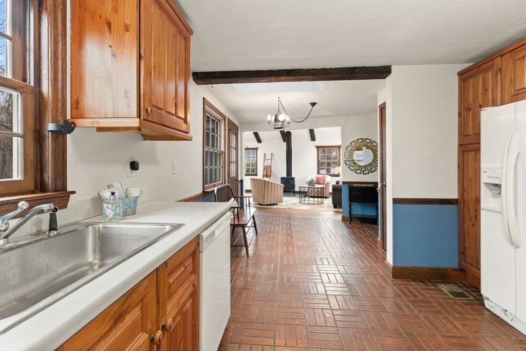 17 Sturges Road Reading, MA 01867 - Photo 9 of 29 a kitchen with stainless steel appliances granite countertop a sink and dishwasher with wooden floor
