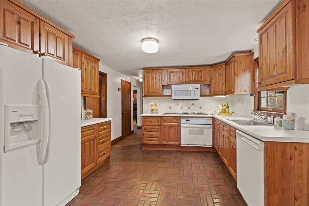 17 Sturges Road Reading, MA 01867 - Photo 10 of 29 a kitchen with stainless steel appliances granite countertop a refrigerator sink and cabinets