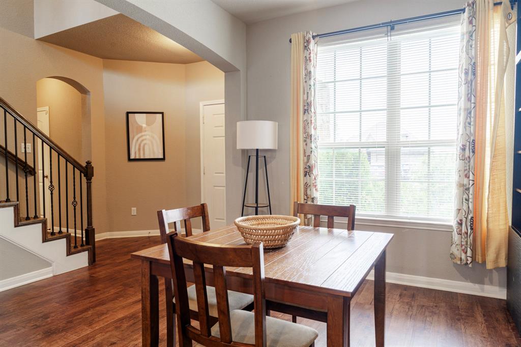 2716 Beutel Road Lorena, TX 76655 - Photo 22 of 39 a view of a a dining room with furniture window and wooden floor