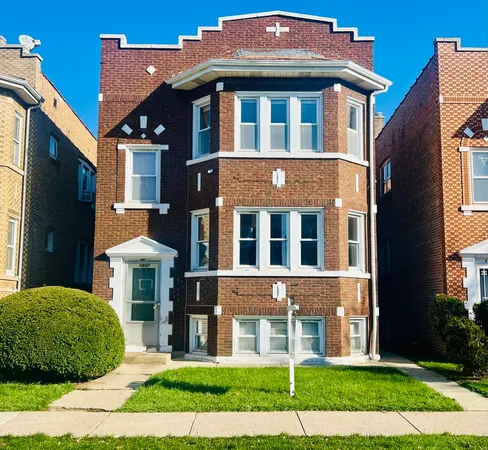 a view of a brick building next to a yard