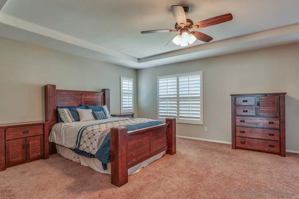 32758 Stonefield Lane Temecula, CA 92592 - Photo 14 of 30 a bed room with a bed and a ceiling fan