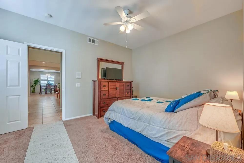 32758 Stonefield Lane Temecula, CA 92592 - Photo 20 of 30 a bedroom with a bed and a chandelier