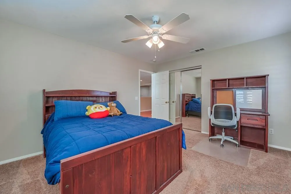 32758 Stonefield Lane Temecula, CA 92592 - Photo 21 of 30 a bedroom with a bed and a chandelier