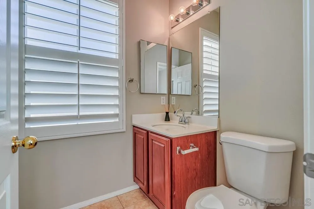 32758 Stonefield Lane Temecula, CA 92592 - Photo 25 of 30 a bathroom with a toilet sink and mirror