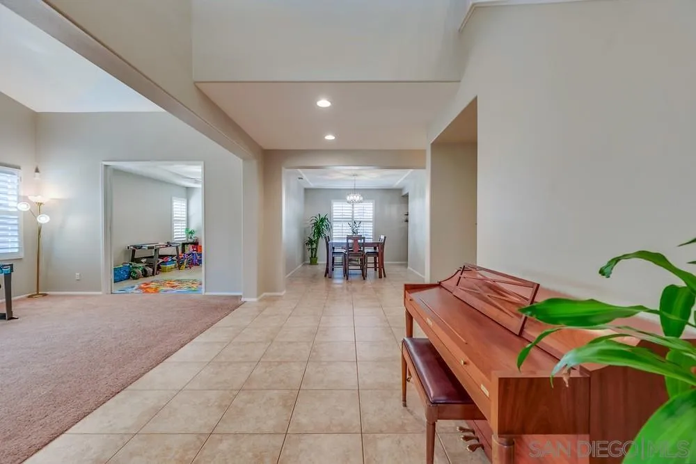 32758 Stonefield Lane Temecula, CA 92592 - Photo 3 of 30 a view of a dining room with furniture and a chandelier