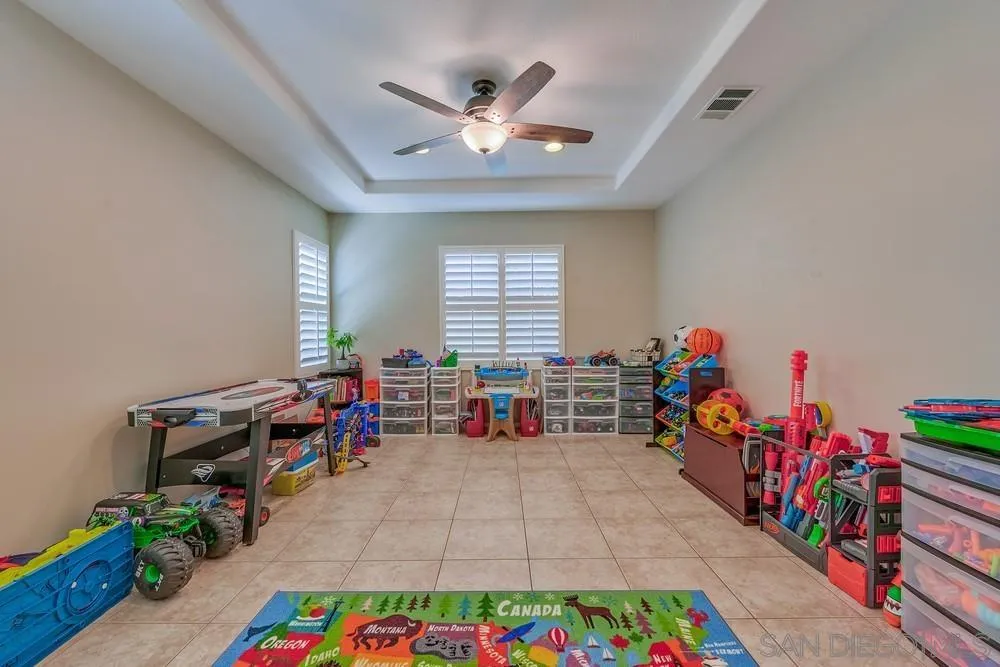 32758 Stonefield Lane Temecula, CA 92592 - Photo 10 of 30 wooden floor in a room with toys and a chandelier