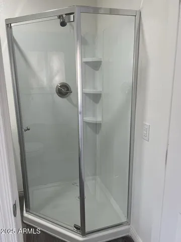 a bathroom with a glass shower door