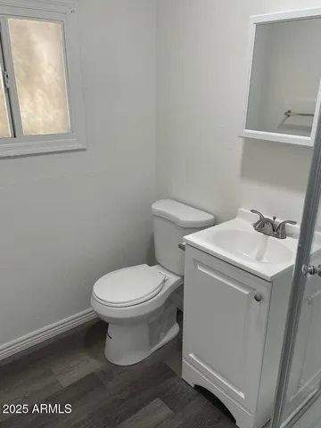 a white toilet sitting next to a bathroom sink