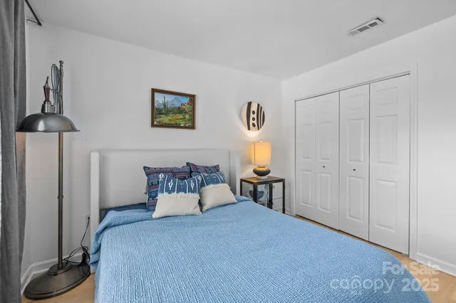 a bedroom with a bed and a table in it