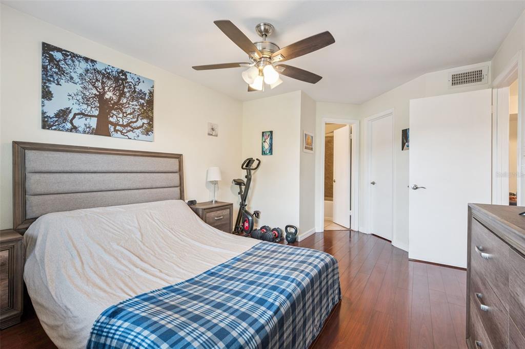 3032 Parkway Boulevard, Unit 305 Kissimmee, FL 34747 - Photo 15 of 40 a bedroom with a bed and a chandelier