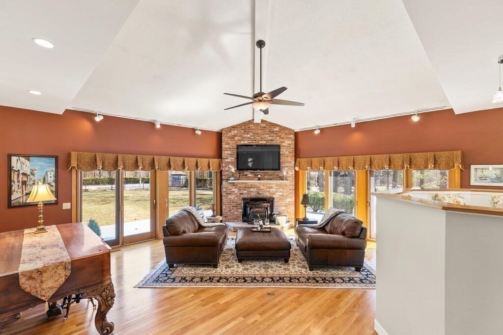 18 Appleton Lane Boxford, MA 01921 - Photo 13 of 42 a living room with fireplace furniture and a floor to ceiling window