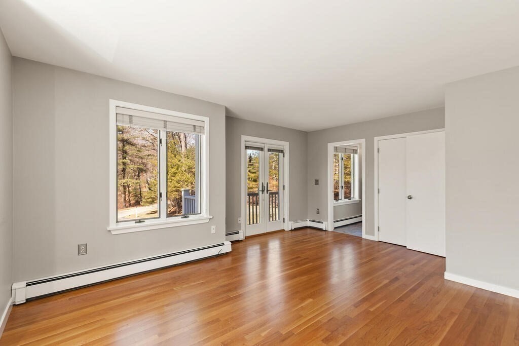 18 Appleton Lane Boxford, MA 01921 - Photo 31 of 42 an empty room with wooden floor and windows