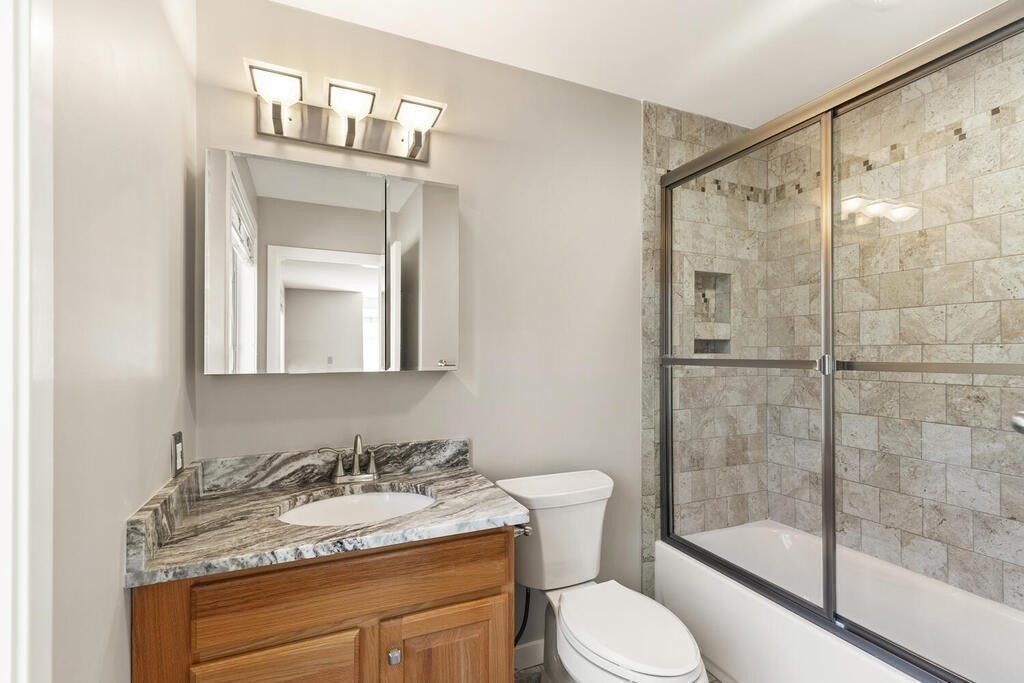 18 Appleton Lane Boxford, MA 01921 - Photo 32 of 42 a bathroom with a granite countertop sink toilet a mirror and shower