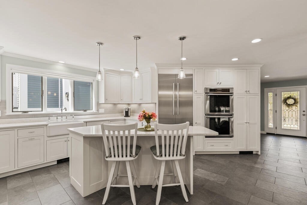 18 Appleton Lane Boxford, MA 01921 - Photo 8 of 42 a kitchen with stainless steel appliances kitchen island granite countertop a dining table chairs and sink