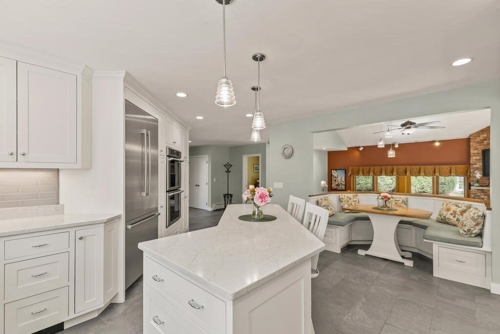 18 Appleton Lane Boxford, MA 01921 - Photo 9 of 42 a large white kitchen with a stove a sink a refrigerator and white cabinets with wooden floor