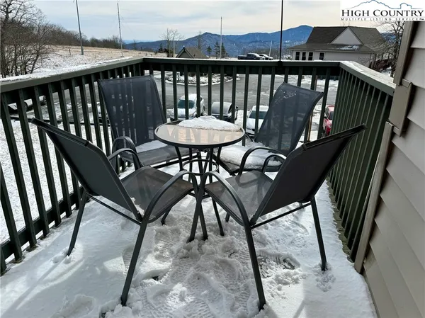a view of a balcony with furniture