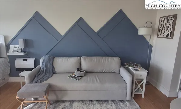 a bed room with a bed and a chair