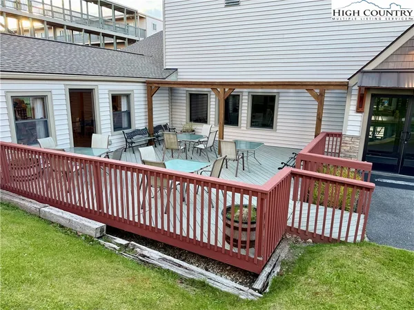 a view of a house with a yard and table under an umbrella