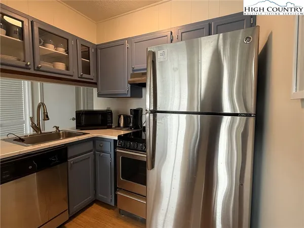 a kitchen with stainless steel appliances a refrigerator and cabinets