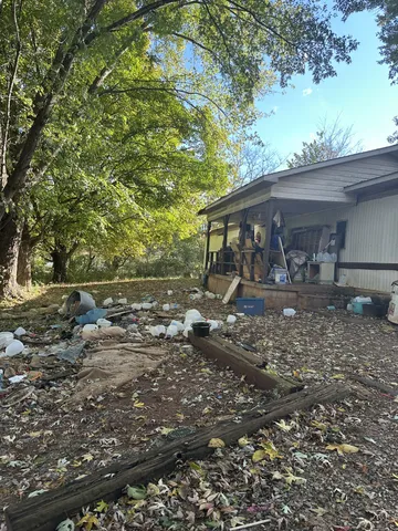a backyard of a house with barbeque oven