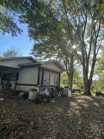 a view of a backyard with a large tree