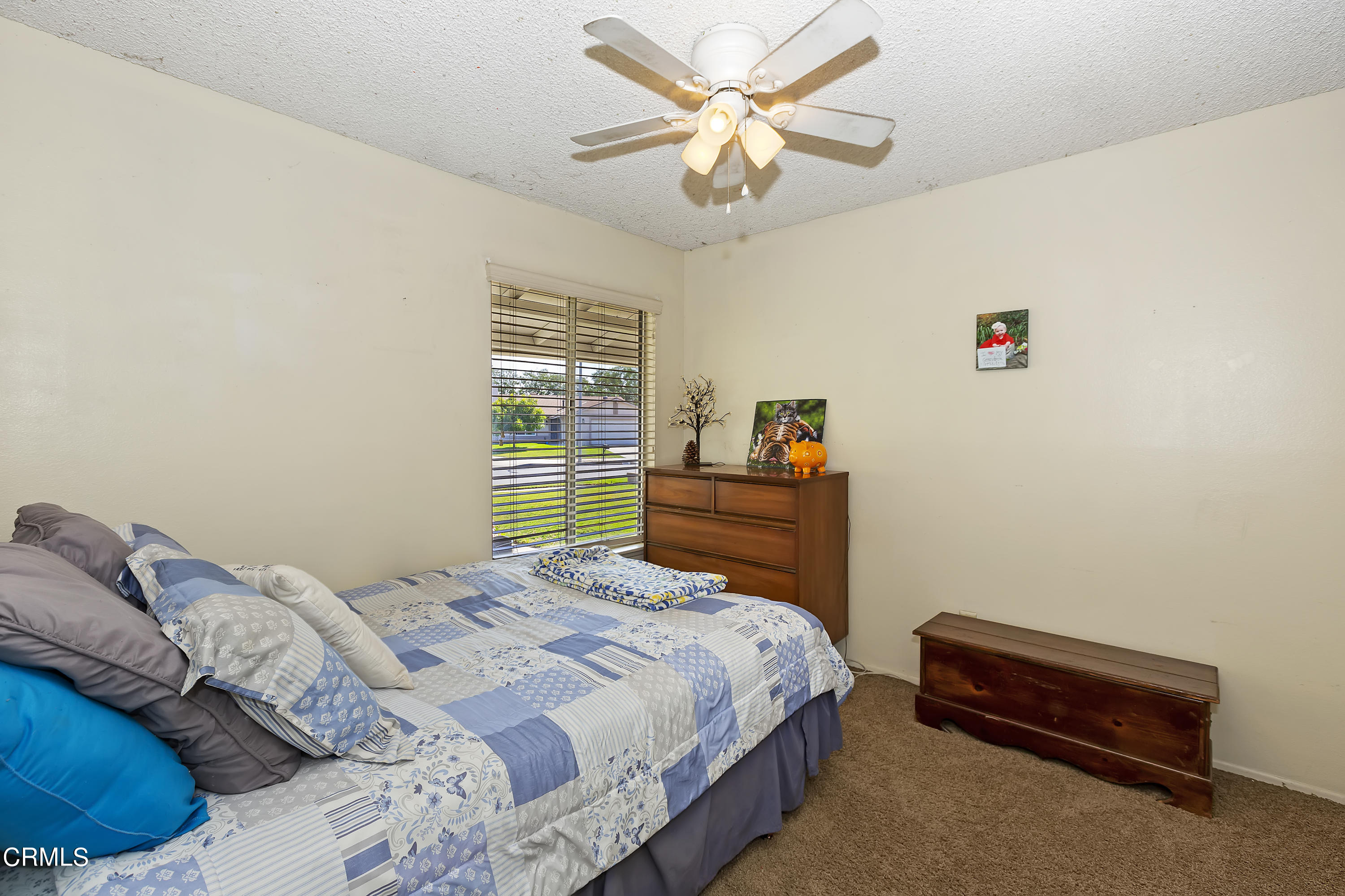 9245 Devon Street Rancho Cucamonga, CA 91730 - Photo 14 of 22 a bedroom with a bed and a chandelier
