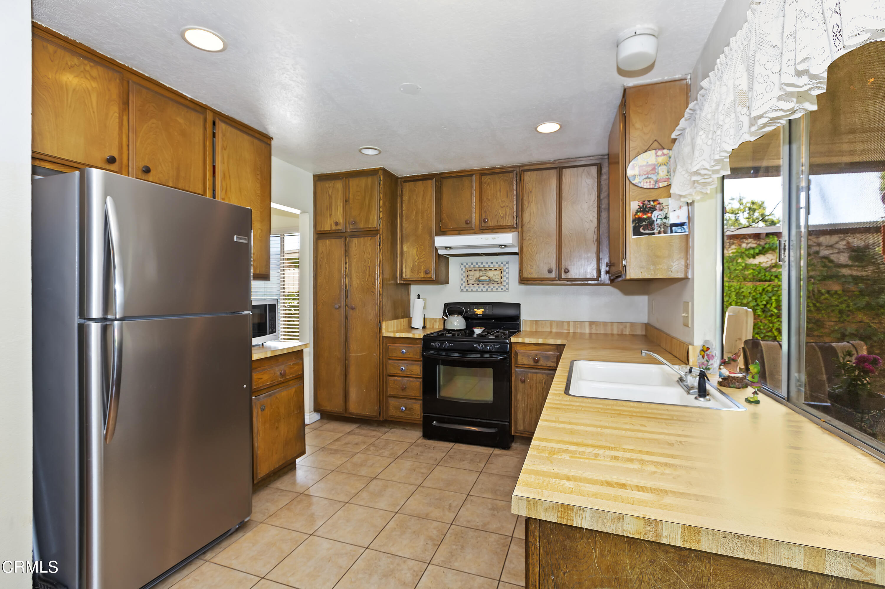 9245 Devon Street Rancho Cucamonga, CA 91730 - Photo 16 of 22 a kitchen with stainless steel appliances granite countertop a refrigerator a stove and a sink