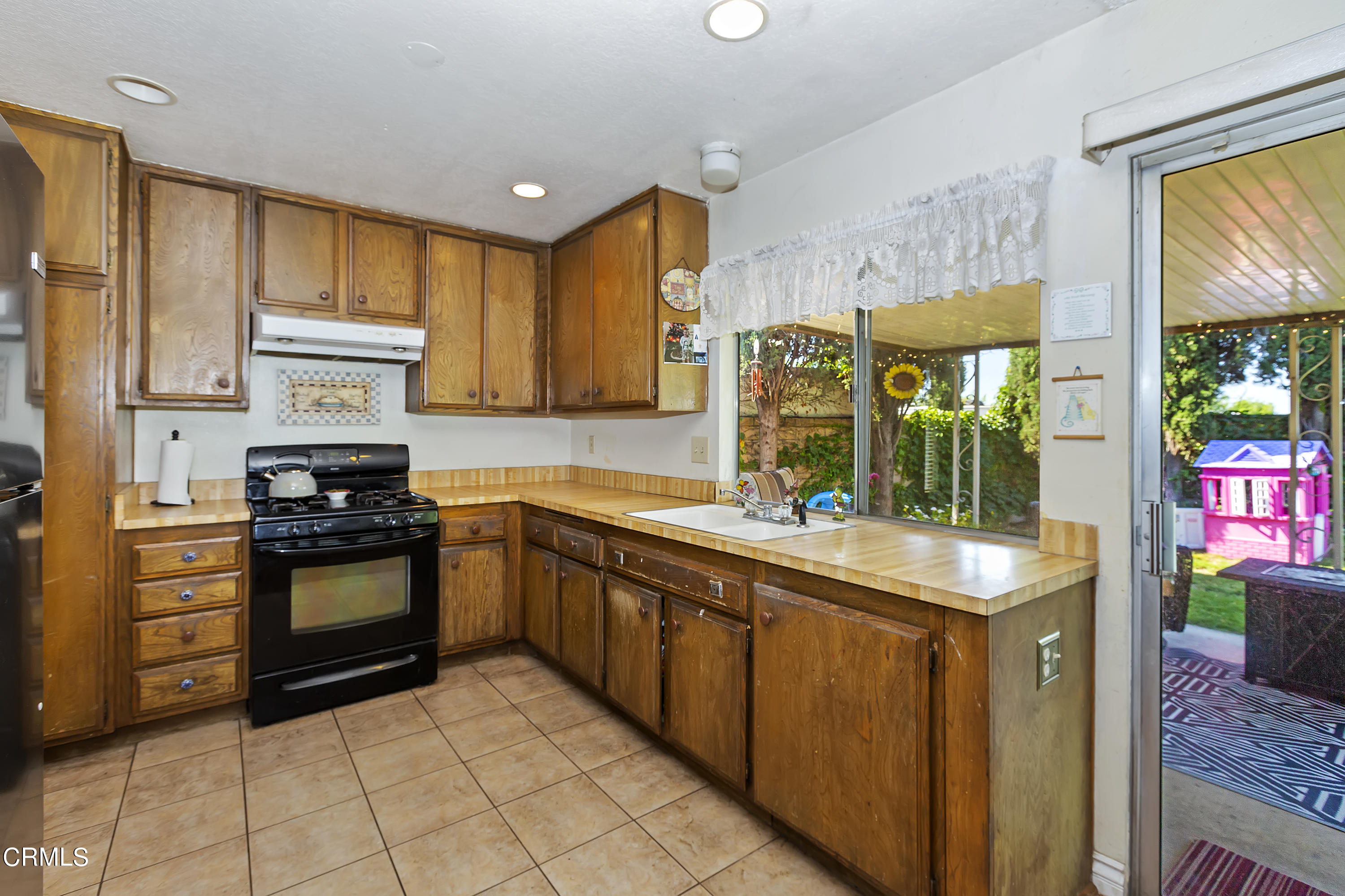 9245 Devon Street Rancho Cucamonga, CA 91730 - Photo 17 of 22 a kitchen with stainless steel appliances granite countertop a stove a sink and a refrigerator