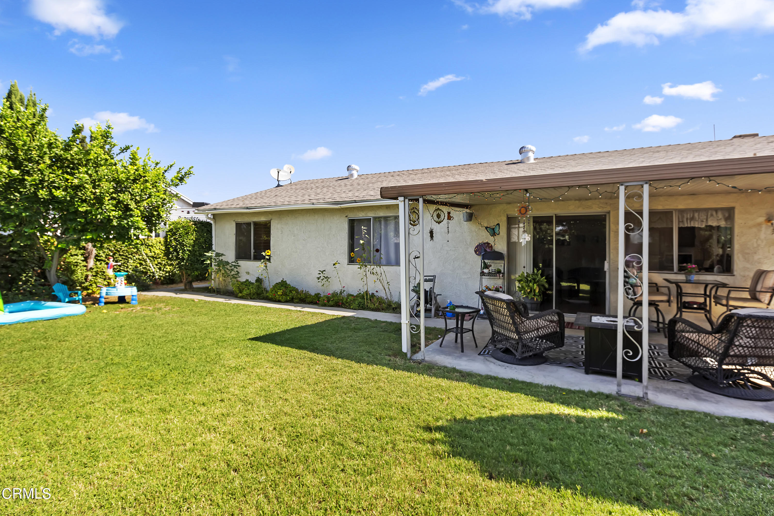 9245 Devon Street Rancho Cucamonga, CA 91730 - Photo 20 of 22 a view of a patio with table and chairs under an umbrella next to a yard