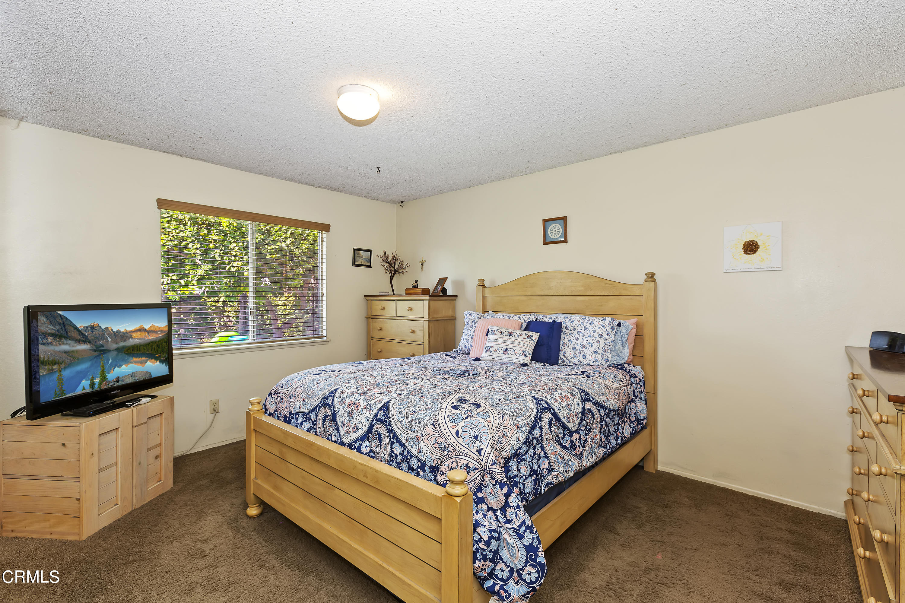 9245 Devon Street Rancho Cucamonga, CA 91730 - Photo 9 of 22 a bedroom with a bed and a flat screen tv