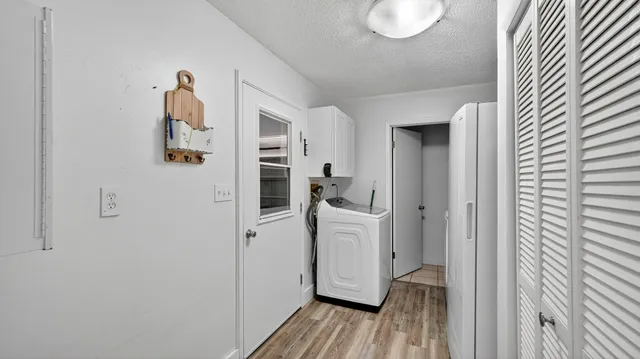 a view of kitchen with stainless steel appliances kitchen island granite countertop a refrigerator and a stove