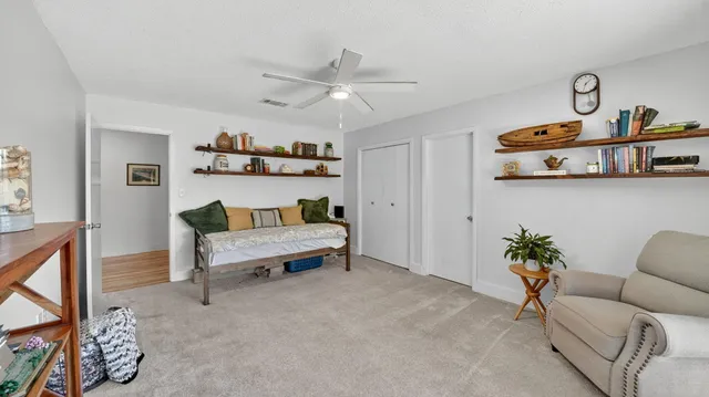 a bedroom with a bed and a dresser in it