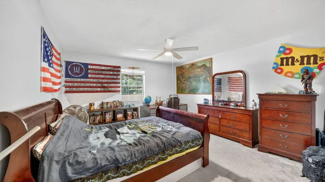 a bathroom with a granite countertop sink mirror vanity and a toilet
