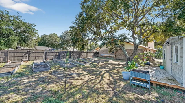 a view of a patio with table and chairs and potted plants