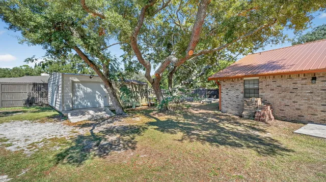 a view of a swimming pool with a yard and seating area