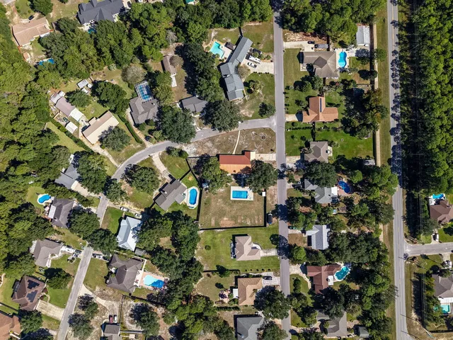 an aerial view of multiple houses with yard