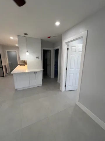 a view of kitchen with furniture and a refrigerator