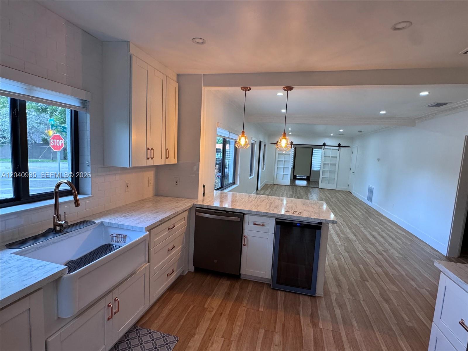 375 Southwest 32nd Road Miami, FL 33129 - Photo 35 of 44 a large kitchen with cabinets and wooden floor