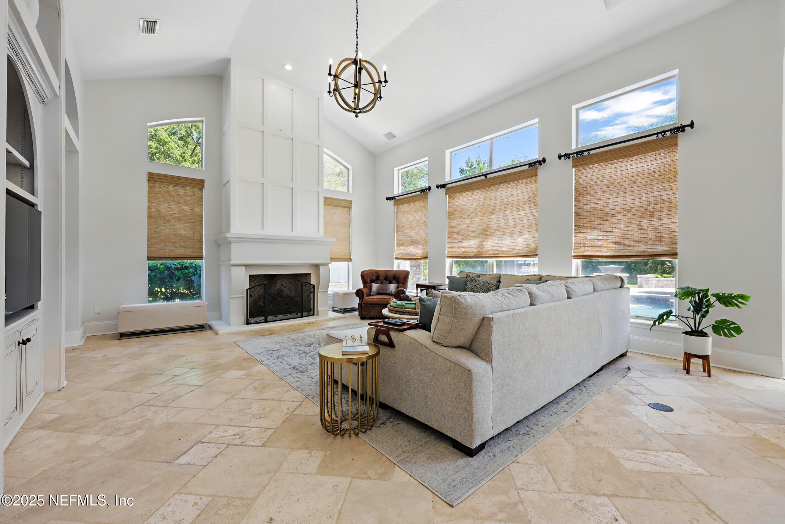 8007 Acorn Ridge Road Jacksonville, FL 32256 - Photo 12 of 76 a living room with furniture large window and a fireplace