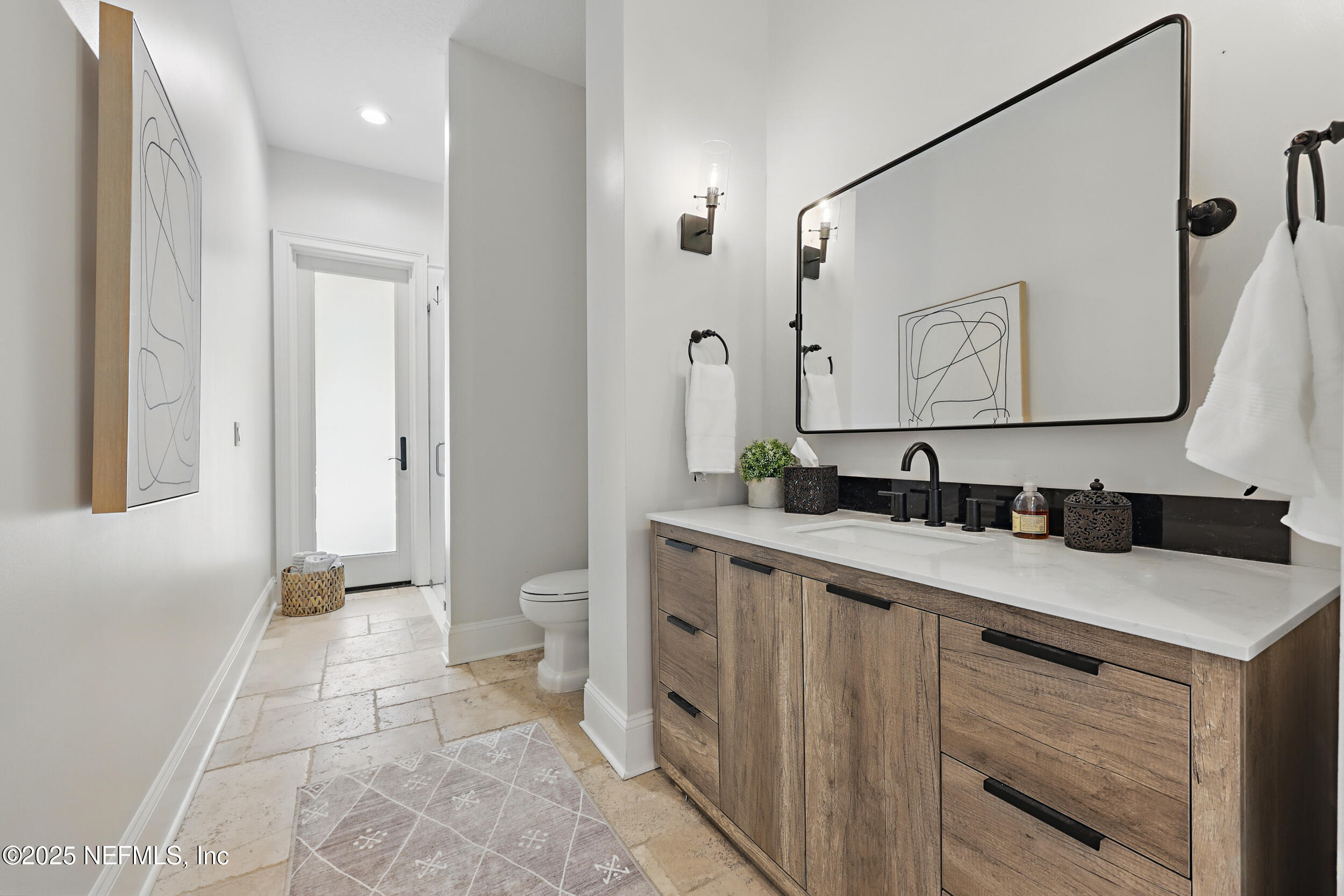 8007 Acorn Ridge Road Jacksonville, FL 32256 - Photo 24 of 76 a bathroom with a sink and a mirror