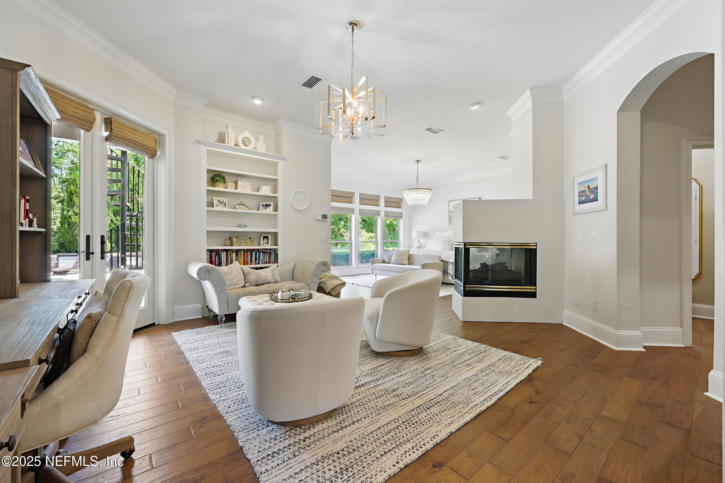 8007 Acorn Ridge Road Jacksonville, FL 32256 - Photo 25 of 76 a living room with furniture a large window and a fireplace