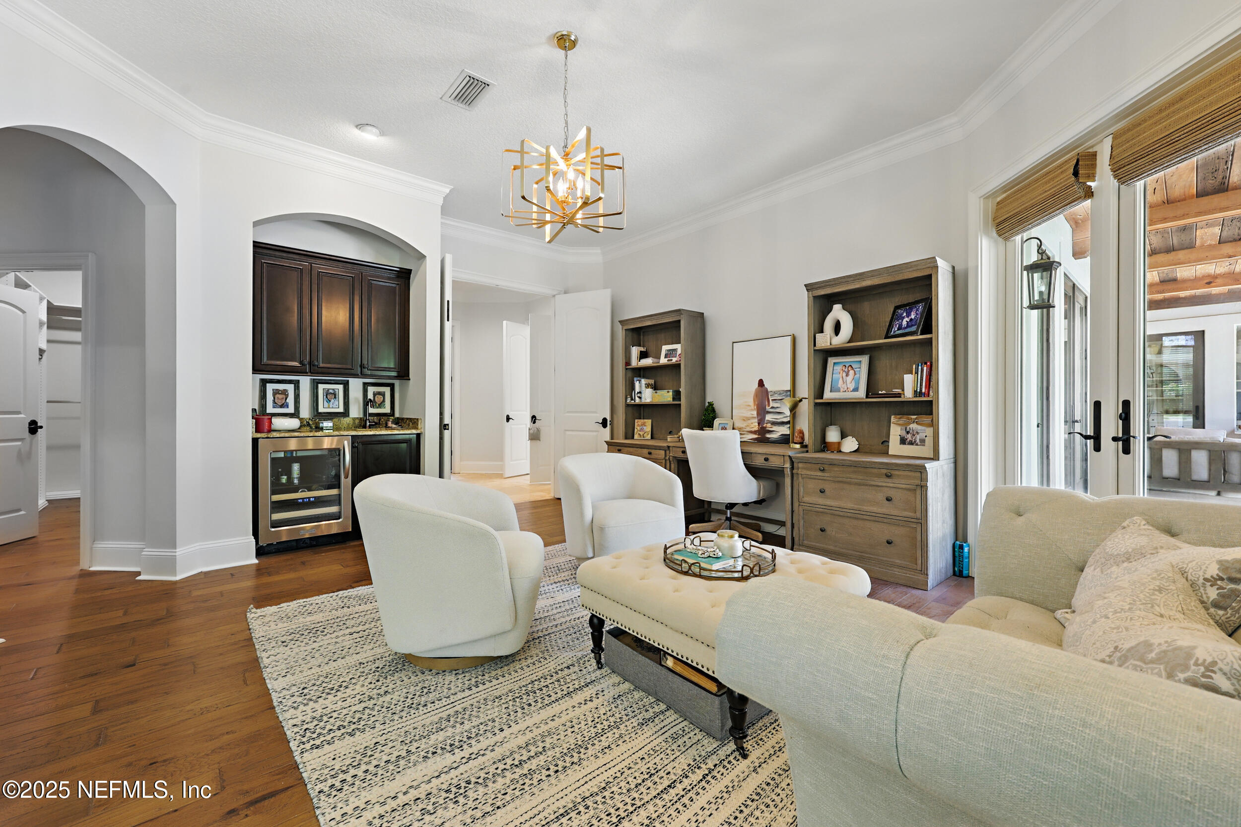 8007 Acorn Ridge Road Jacksonville, FL 32256 - Photo 27 of 76 a living room with furniture and a chandelier