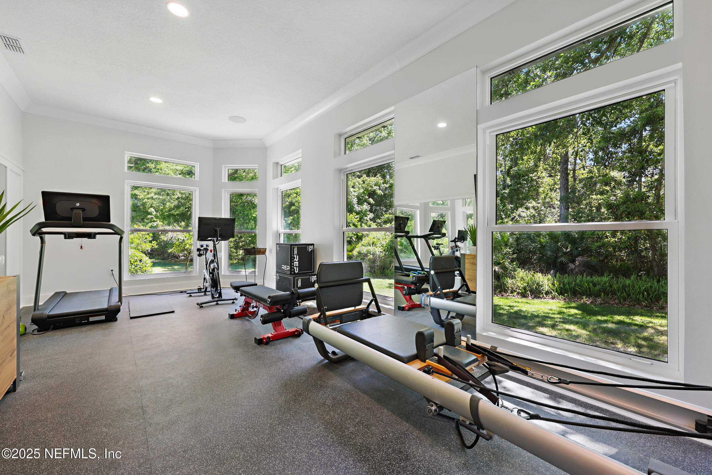 8007 Acorn Ridge Road Jacksonville, FL 32256 - Photo 32 of 76 a view of a room with gym equipment and a large window