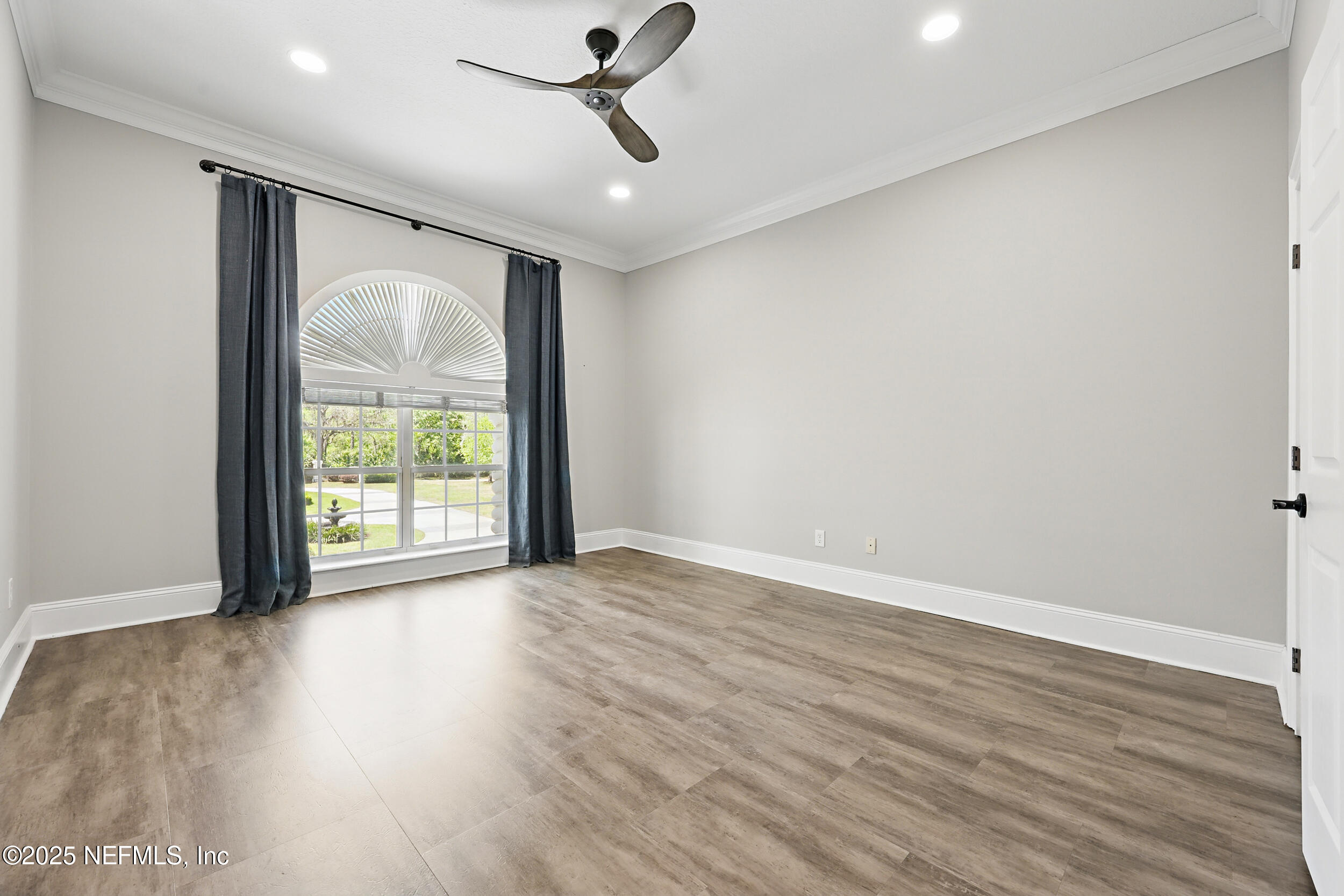 8007 Acorn Ridge Road Jacksonville, FL 32256 - Photo 39 of 76 a view of an empty room with wooden floor and a window