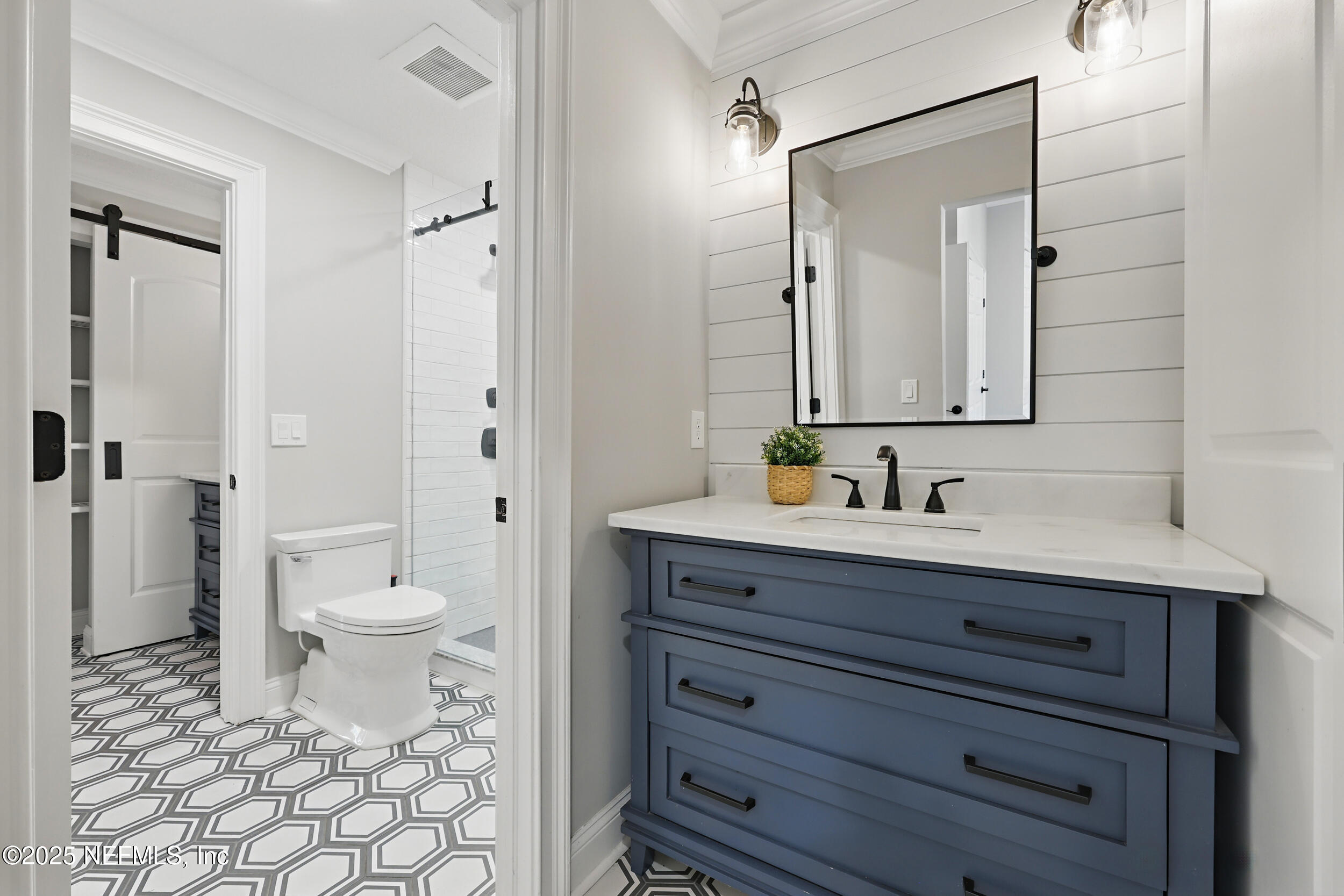 8007 Acorn Ridge Road Jacksonville, FL 32256 - Photo 40 of 76 a bathroom with a granite countertop sink toilet mirror and a shower