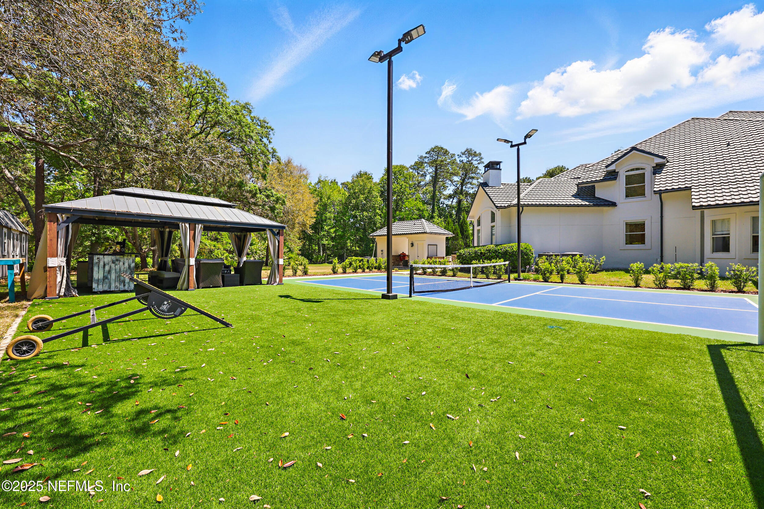 8007 Acorn Ridge Road Jacksonville, FL 32256 - Photo 68 of 76 a view of a house with a big yard and potted plants